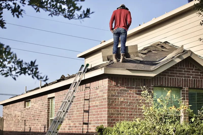 Professional roofer working on a residential roof in Pecan Grove